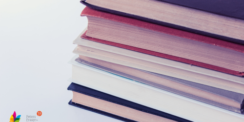 Close up of six books stacked on white background